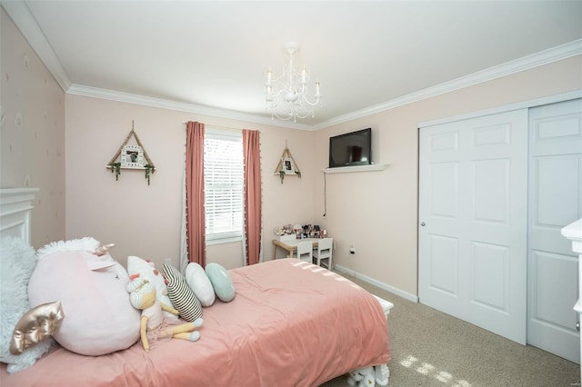 carpeted bedroom featuring a chandelier, a closet, baseboards, and crown molding