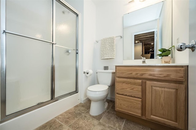 full bathroom with a shower with shower door, vanity, and toilet