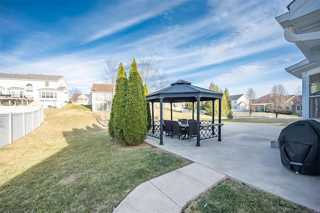 view of yard featuring a gazebo, a patio area, fence, and a residential view