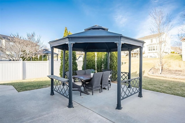 view of patio / terrace with a gazebo, fence, and outdoor dining space