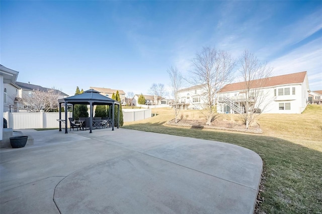 view of yard featuring a residential view, a patio area, fence, and a gazebo