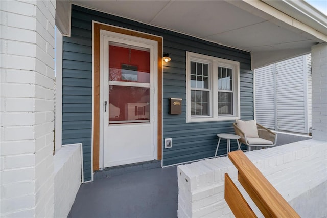 view of exterior entry featuring a porch