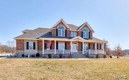 view of front of home featuring covered porch and a front yard