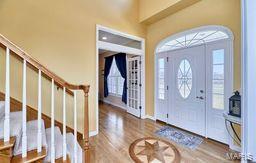 entrance foyer featuring stairway and wood finished floors