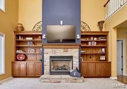 living area with light colored carpet and a fireplace