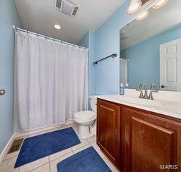 full bathroom with tile patterned floors, visible vents, toilet, a shower with shower curtain, and vanity