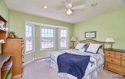 bedroom with carpet flooring, baseboards, and a ceiling fan