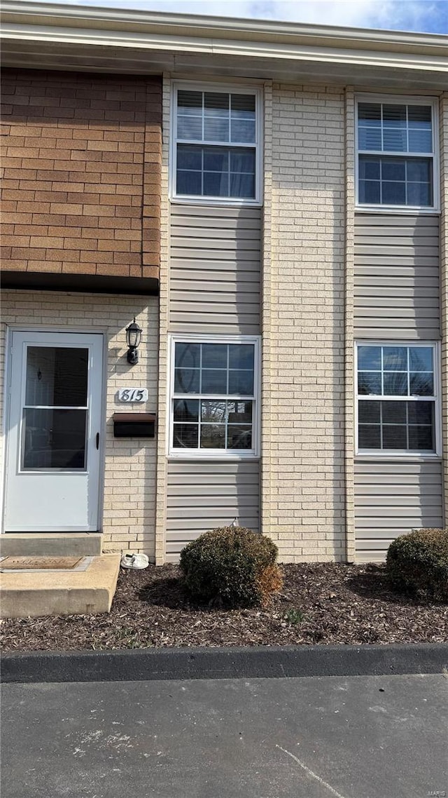 property entrance with brick siding