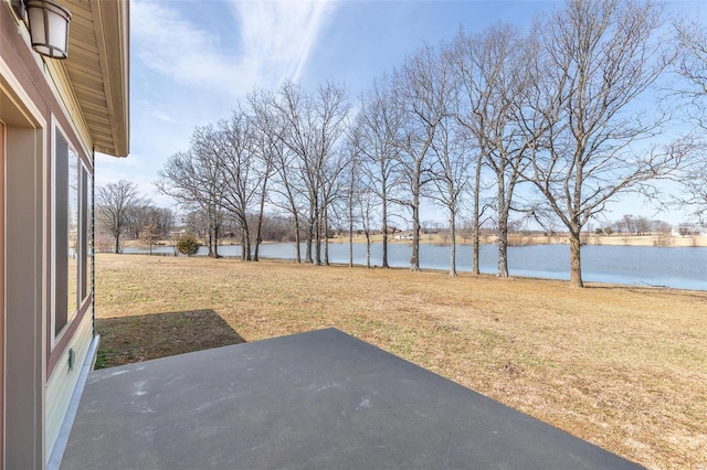 view of yard featuring a water view and a patio