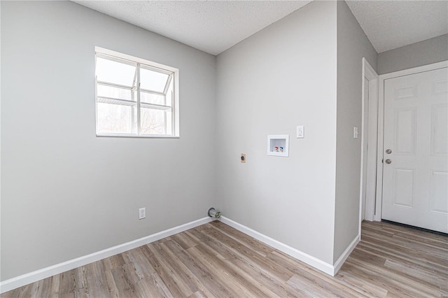 washroom with baseboards, washer hookup, laundry area, light wood-style flooring, and hookup for an electric dryer