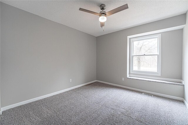 carpeted spare room featuring ceiling fan, baseboards, visible vents, and a textured ceiling