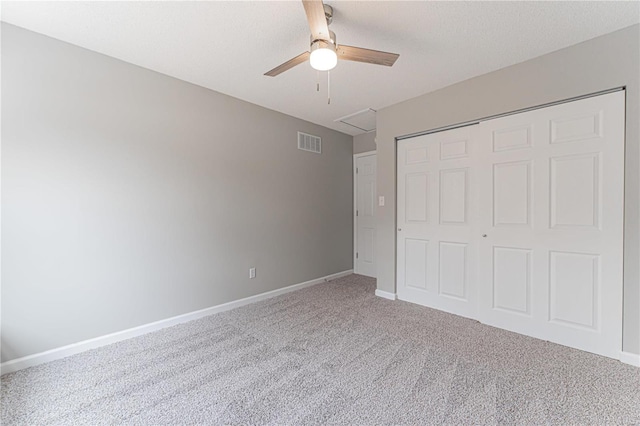 unfurnished bedroom with visible vents, a closet, carpet floors, baseboards, and ceiling fan