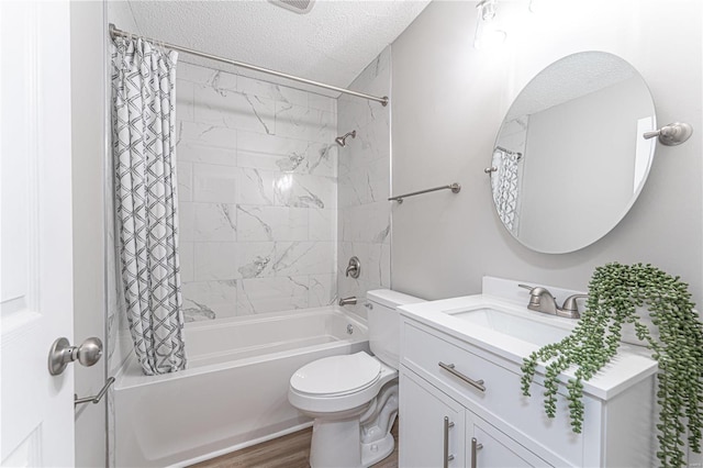 full bathroom featuring toilet, a textured ceiling, wood finished floors, shower / tub combo, and vanity