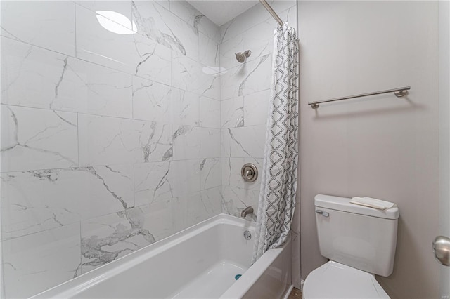 bathroom featuring shower / bath combo with shower curtain and toilet