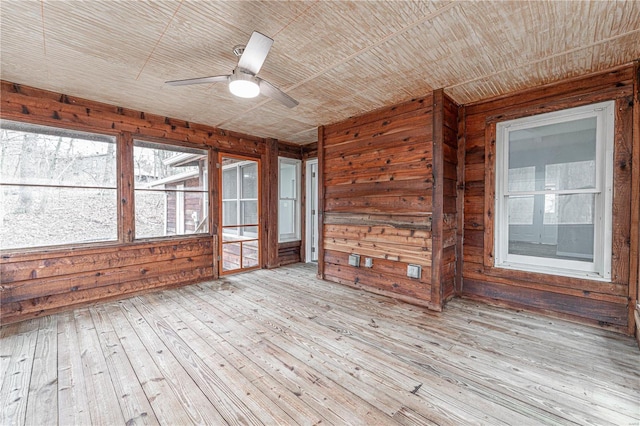 unfurnished sunroom with a ceiling fan