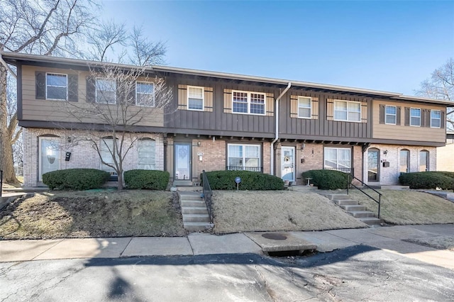 townhome / multi-family property with board and batten siding and brick siding