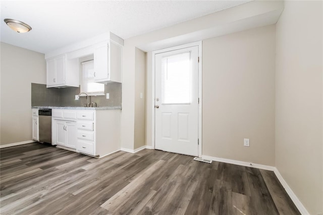 kitchen featuring dark wood-style floors, light countertops, white cabinetry, and tasteful backsplash