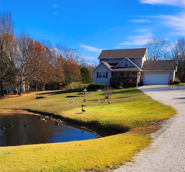 view of front of property with a front yard, gravel driveway, and an attached garage