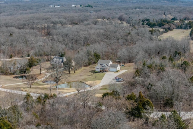 drone / aerial view featuring a view of trees and a water view