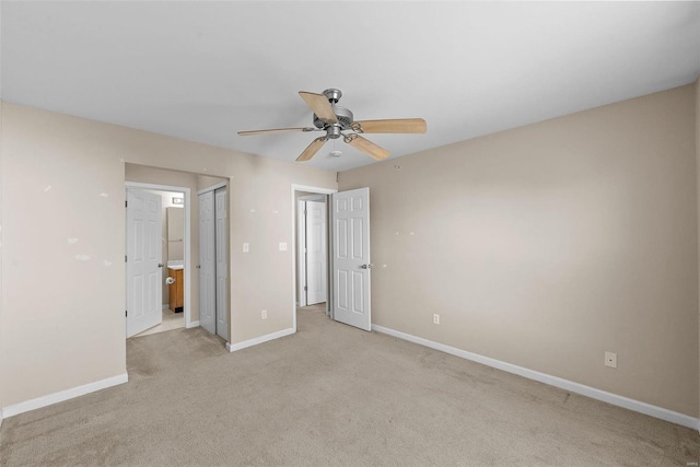 unfurnished bedroom with a ceiling fan, light carpet, connected bathroom, and baseboards