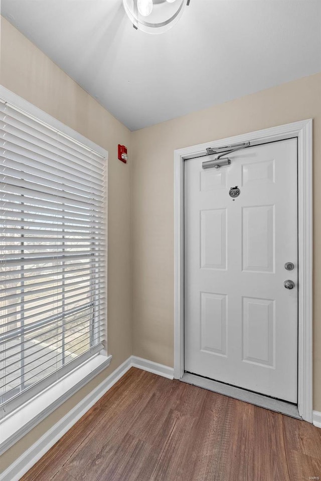 interior space with wood finished floors and baseboards