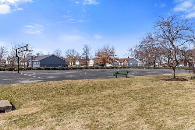 view of yard featuring community basketball court and a residential view