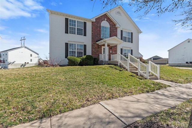 view of front of property featuring brick siding and a front lawn