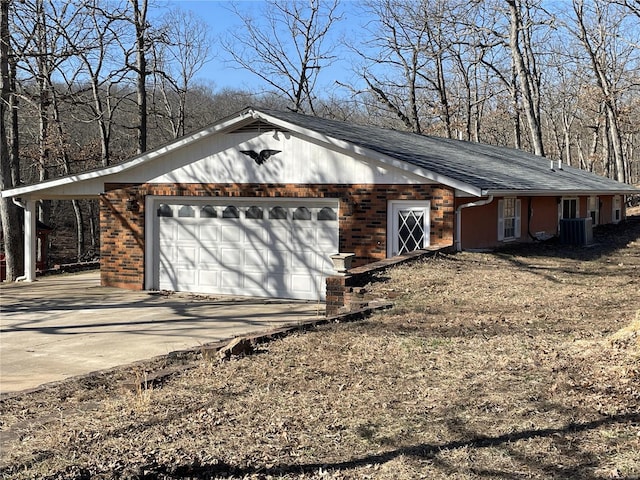 garage featuring cooling unit and driveway