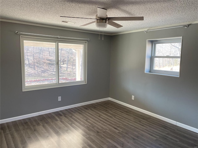 unfurnished room featuring dark wood-style floors, ceiling fan, a textured ceiling, and baseboards