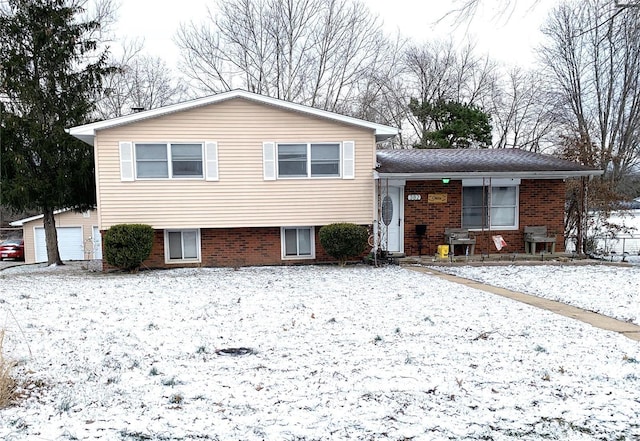 tri-level home with brick siding and an outdoor structure