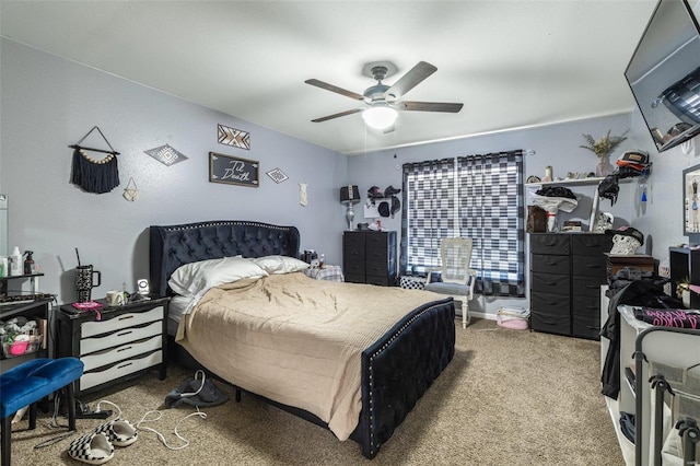 bedroom with a ceiling fan and carpet flooring