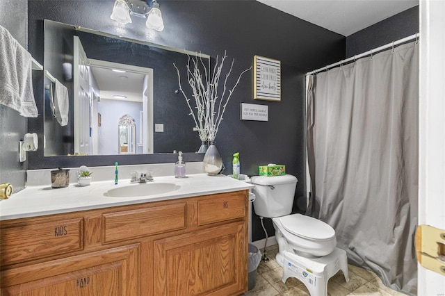 bathroom with toilet, curtained shower, tile patterned flooring, and vanity