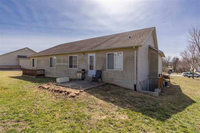 rear view of property with a lawn and a patio