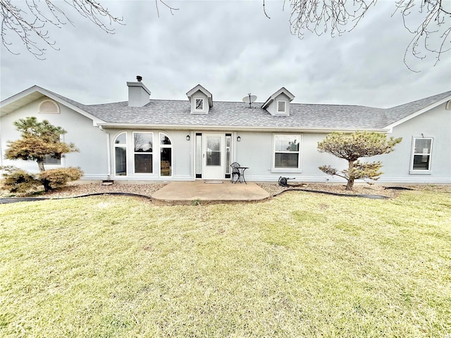 back of house featuring a yard, a shingled roof, a patio, and stucco siding