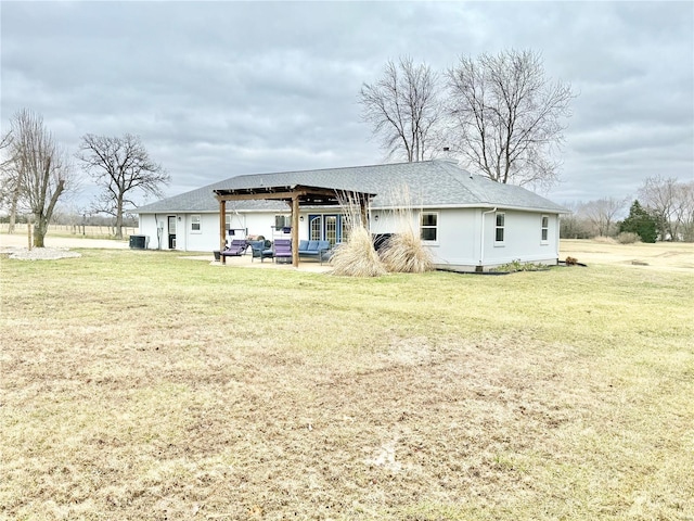 rear view of house featuring a yard, central AC unit, and a patio area