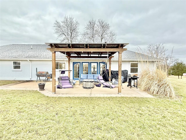 back of house featuring a patio, an outdoor fire pit, a yard, roof with shingles, and stucco siding