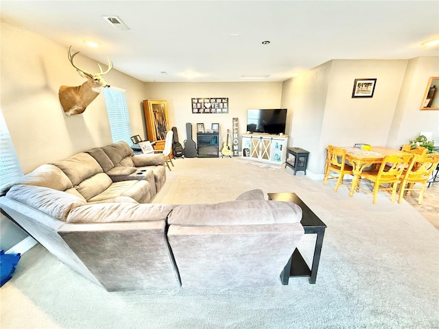 living area featuring carpet floors and visible vents