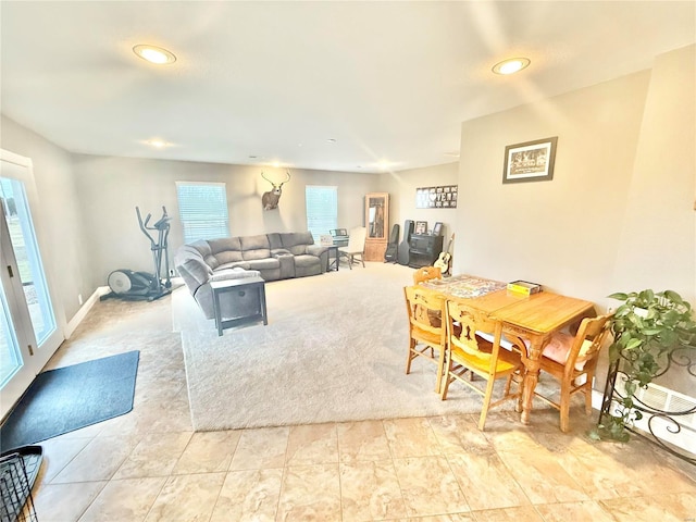 living room featuring baseboards and recessed lighting