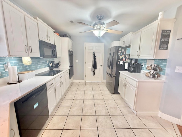 kitchen with light countertops, white cabinets, light tile patterned flooring, and black appliances