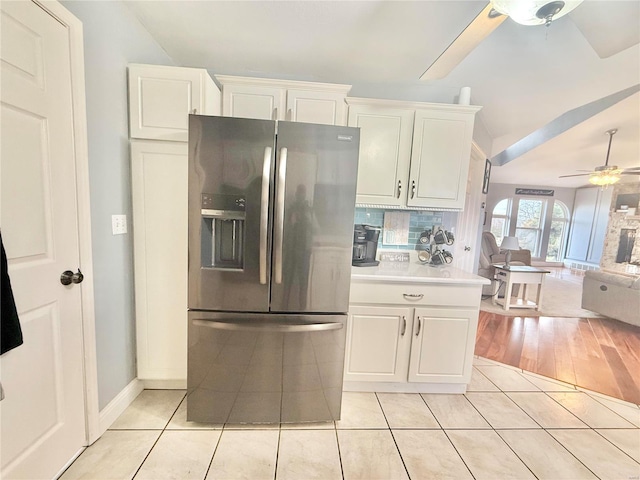 kitchen with light tile patterned floors, a ceiling fan, open floor plan, white cabinetry, and stainless steel refrigerator with ice dispenser