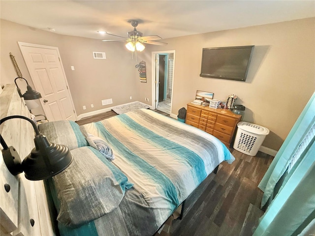 bedroom with visible vents, baseboards, and wood finished floors