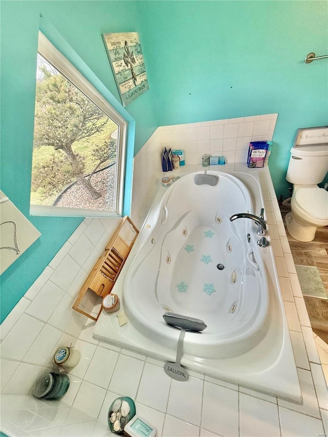 full bath featuring a jetted tub and toilet