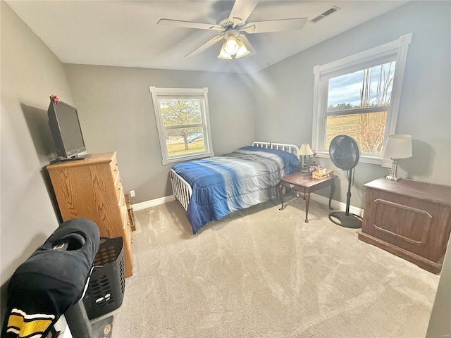 carpeted bedroom with a ceiling fan, visible vents, and baseboards