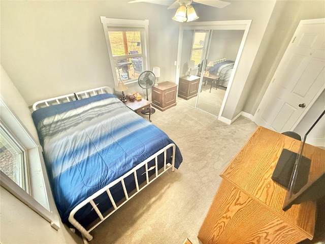 bedroom featuring carpet, a ceiling fan, and baseboards