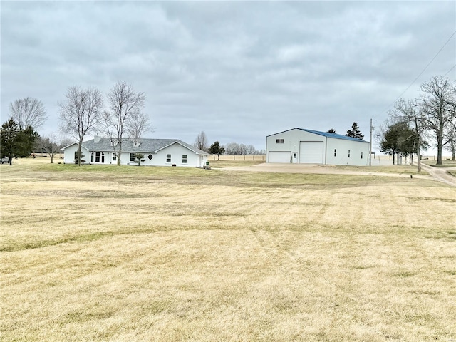 view of yard featuring a garage and an outdoor structure