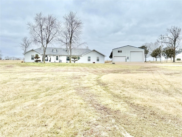 view of yard featuring a detached garage and an outdoor structure