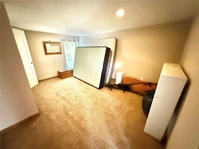 interior space with baseboards, carpet flooring, and an AC wall unit