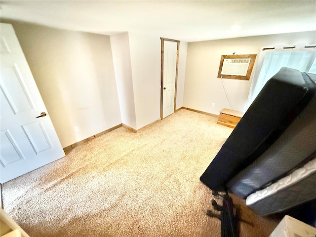 unfurnished room with carpet floors, a wall mounted air conditioner, and baseboards