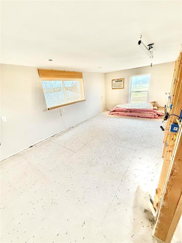 unfurnished room featuring a wall mounted air conditioner