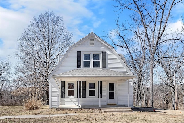 dutch colonial featuring a shingled roof, a porch, and a gambrel roof